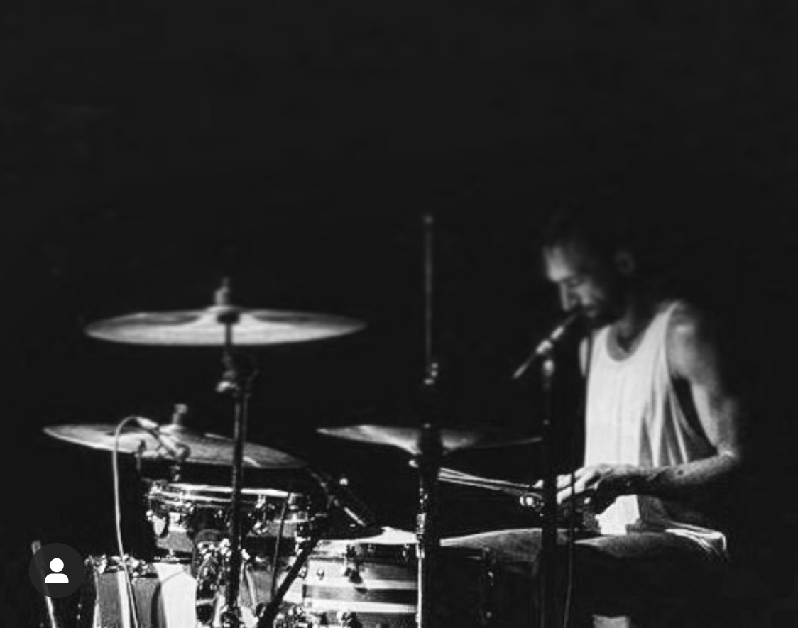 Chris Collis playing drums on stage